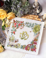 Create this beautifully designed Matzah cover for an elegant addition to your Passover table.  The Hebrew word for Passover (Pesach) is encircled with symbols of spring and many of the meaningful elements from the Seder plate. This cross-stitched Matzah cover will be a cherished heirloom to be enjoyed year after year at your family Seder.  large easy to read chart with instructions included for making the three pocket design.