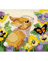 AN ADORABLE FLOPPY EARRED 'RARE-BIT' chasing butterflies in the flower garden.