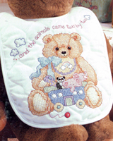 A bib set to go with the God Bless Baby crib cover.