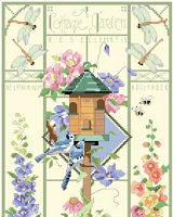 This delicate and beautiful greenhouse style design by Nancy Rossi brings the outside ‘in’ with lovely depictions of Roses, Clematis, Delphinium, Hollyhocks and more. Birds, frogs and insects flit and flutter about the classic and elegant birdhouse which is the focal point of this design.